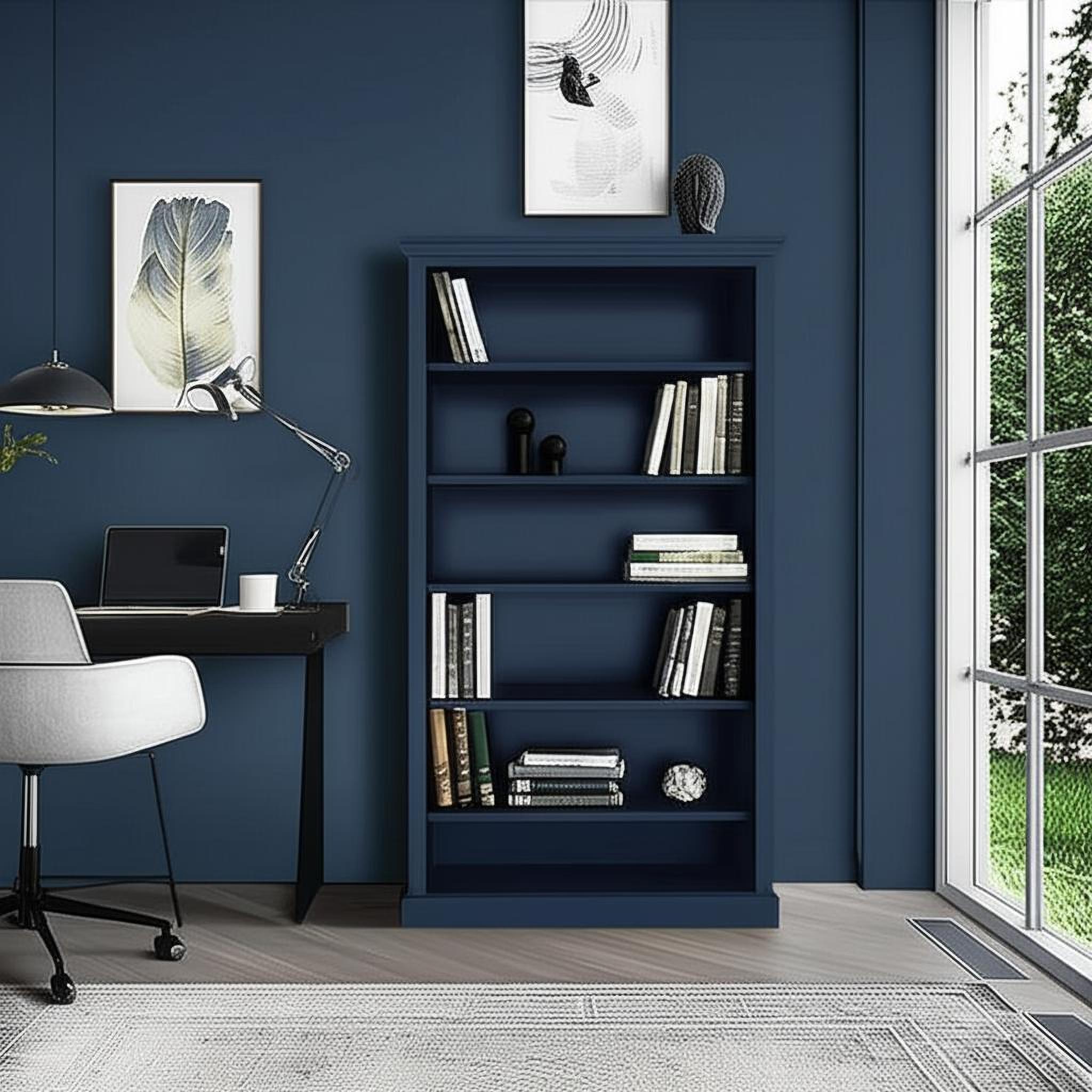 Dark blue home office with a bookcase and desk in a styled interior.